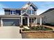 Beautiful two-story home featuring a two-car garage, well-maintained lawn, and stylish blue siding at 2085 Saddlebred Dr, Iron Station, NC 28080