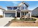 Beautiful two-story home featuring a two-car garage, well-maintained lawn, and stylish blue siding at 2085 Saddlebred Dr, Iron Station, NC 28080