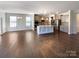 Open-concept kitchen with stainless steel appliances, granite countertops, and a large island at 2085 Saddlebred Dr, Iron Station, NC 28080