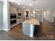 Modern kitchen featuring stainless steel appliances, granite countertops, and a central island at 2085 Saddlebred Dr, Iron Station, NC 28080