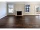 Spacious room offers hardwood floors, neutral walls, a fireplace and windows with natural light at 2085 Saddlebred Dr, Iron Station, NC 28080