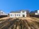 Back exterior of home with a large yard, and well-maintained features at 2115 Genesis Dr, Monroe, NC 28110