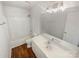 Clean, updated bathroom with a modern vanity and shower-tub combination with wood flooring at 2115 Genesis Dr, Monroe, NC 28110
