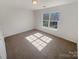 Carpeted bedroom featuring a large window that provides ample natural light at 2115 Genesis Dr, Monroe, NC 28110