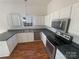 Efficient kitchen with stainless steel appliances, wood flooring, and white cabinets at 2115 Genesis Dr, Monroe, NC 28110