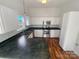 Well-lit kitchen featuring white cabinetry, stainless steel appliances, and dark countertops at 2115 Genesis Dr, Monroe, NC 28110