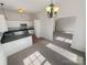 Open floor plan that flows from kitchen to carpeted living space with modern light fixtures at 2115 Genesis Dr, Monroe, NC 28110