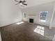 Spacious living room featuring neutral colors, a ceiling fan, fireplace and large windows at 2115 Genesis Dr, Monroe, NC 28110