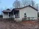 Exterior side view of a home with a covered porch, showing its architectural style and surroundings at 2124 Shoal Rd, Lincolnton, NC 28092