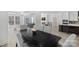 Dining room with dark wood table and gray chairs, seamlessly connects to the living room and kitchen at 218 Alenda Lux Cir, Mooresville, NC 28115