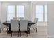 Dining room featuring a dark wood table with gray chairs and natural light, providing an inviting atmosphere at 218 Alenda Lux Cir, Mooresville, NC 28115