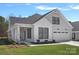 Beautiful home with white siding, black trim windows, well-manicured lawn, and attached two car garage at 218 Alenda Lux Cir, Mooresville, NC 28115