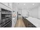 Contemporary kitchen featuring stainless steel appliances, light countertops, and stylish backsplash at 218 Alenda Lux Cir, Mooresville, NC 28115