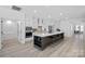 Open-concept kitchen with a large island, stainless steel appliances, and modern finishes at 218 Alenda Lux Cir, Mooresville, NC 28115