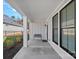Covered front porch featuring classic columns, a black metal bench, and large windows at 218 Alenda Lux Cir, Mooresville, NC 28115
