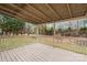Covered back deck with railing provides a great view of the backyard and wooded area at 2225 Grace Church Rd, Salisbury, NC 28147