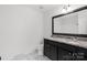 Modern bathroom featuring double vanity with granite countertop and black cabinets at 2225 Grace Church Rd, Salisbury, NC 28147