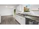 Kitchen featuring a stainless steel dishwasher, sink with stone countertops and light gray flooring at 2225 Grace Church Rd, Salisbury, NC 28147