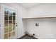 Bright laundry room with white walls, light gray floors, and a large window at 2225 Grace Church Rd, Salisbury, NC 28147