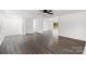 Open living room with light gray flooring, a white interior, and a glass door leading to the outside at 2225 Grace Church Rd, Salisbury, NC 28147