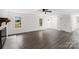 Bright living room featuring light gray flooring, a white-painted brick fireplace, and two large windows at 2225 Grace Church Rd, Salisbury, NC 28147
