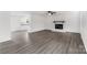 Spacious living room with light gray flooring, fireplace, and open view to the kitchen at 2225 Grace Church Rd, Salisbury, NC 28147