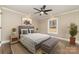 Bright bedroom with a neutral color palette, ceiling fan, and a large window showcasing the outdoor scenery at 24 Eastwinds Dr, Hickory, NC 28601