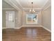 A dining area with hardwood floors, crown molding, a chandelier and a decorative glass window door at 24 Eastwinds Dr, Hickory, NC 28601