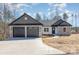 A charming single-story home with a stone and gray shingle accent and a two car garage at 24 Eastwinds Dr, Hickory, NC 28601
