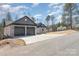 Exterior shot showcasing a charming single-story home with an attached 2-car garage and a long driveway at 24 Eastwinds Dr, Hickory, NC 28601