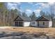 A single-story home with gray shingle and stone accents, set against a backdrop of trees and sky at 24 Eastwinds Dr, Hickory, NC 28601