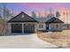 A charming single-story home with a stone and gray shingle accent and a two car garage at 24 Eastwinds Dr, Hickory, NC 28601