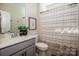 Well-lit bathroom featuring a shower with a curtain, neutral colored walls, and a gray vanity at 242 Hamptons Cove Rd, Troutman, NC 28166