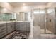 Modern bathroom featuring a glass enclosed shower, neutral tile, double sink vanity, and sleek countertops at 242 Hamptons Cove Rd, Troutman, NC 28166