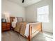 Comfortable bedroom with a wood bed, bedside table, and natural light at 242 Hamptons Cove Rd, Troutman, NC 28166