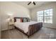 Cozy bedroom with plush bedding, side tables, and a large window at 242 Hamptons Cove Rd, Troutman, NC 28166