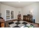 Bonus room featuring wood floors, gym equipment, and natural lighting from the french doors at 242 Hamptons Cove Rd, Troutman, NC 28166