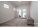Bright bonus room boasts carpet floors, natural light and backyard access through the glass french doors at 242 Hamptons Cove Rd, Troutman, NC 28166