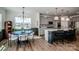 Bright dining area adjacent to the kitchen, featuring elegant chandelier and backyard views at 242 Hamptons Cove Rd, Troutman, NC 28166