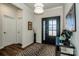 Charming foyer features a black front door, wood floors, and stylish decor at 242 Hamptons Cove Rd, Troutman, NC 28166