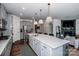 Stylish kitchen with stainless steel appliances, a large island, and an open layout, great for entertaining at 242 Hamptons Cove Rd, Troutman, NC 28166