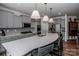 Modern kitchen with stainless steel appliances, sleek countertops, and a spacious island with seating at 242 Hamptons Cove Rd, Troutman, NC 28166