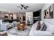 Open-concept living room and kitchen showcasing stylish furnishings and modern design at 242 Hamptons Cove Rd, Troutman, NC 28166