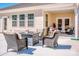 Relaxing covered patio with comfortable seating and modern fire pit area at 242 Hamptons Cove Rd, Troutman, NC 28166