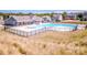 Community pool and recreation area with clubhouse, pool furniture, and a lap pool at 242 Hamptons Cove Rd, Troutman, NC 28166