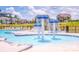 Community pool area featuring a splash pad, tanning chairs, and nearby lounging for relaxing at 242 Hamptons Cove Rd, Troutman, NC 28166