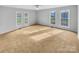 Bedroom features plush carpet, multiple windows, and a ceiling fan, creating a serene retreat at 279 Timberland Loop, Mooresville, NC 28115