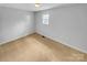 Simple bedroom with neutral carpet and a window offering natural light at 279 Timberland Loop, Mooresville, NC 28115