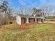 Brick ranch-style home showcases black shutters and a well manicured lawn at 279 Timberland Loop, Mooresville, NC 28115