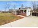 Charming brick ranch-style home features black shutters and a well manicured yard at 279 Timberland Loop, Mooresville, NC 28115